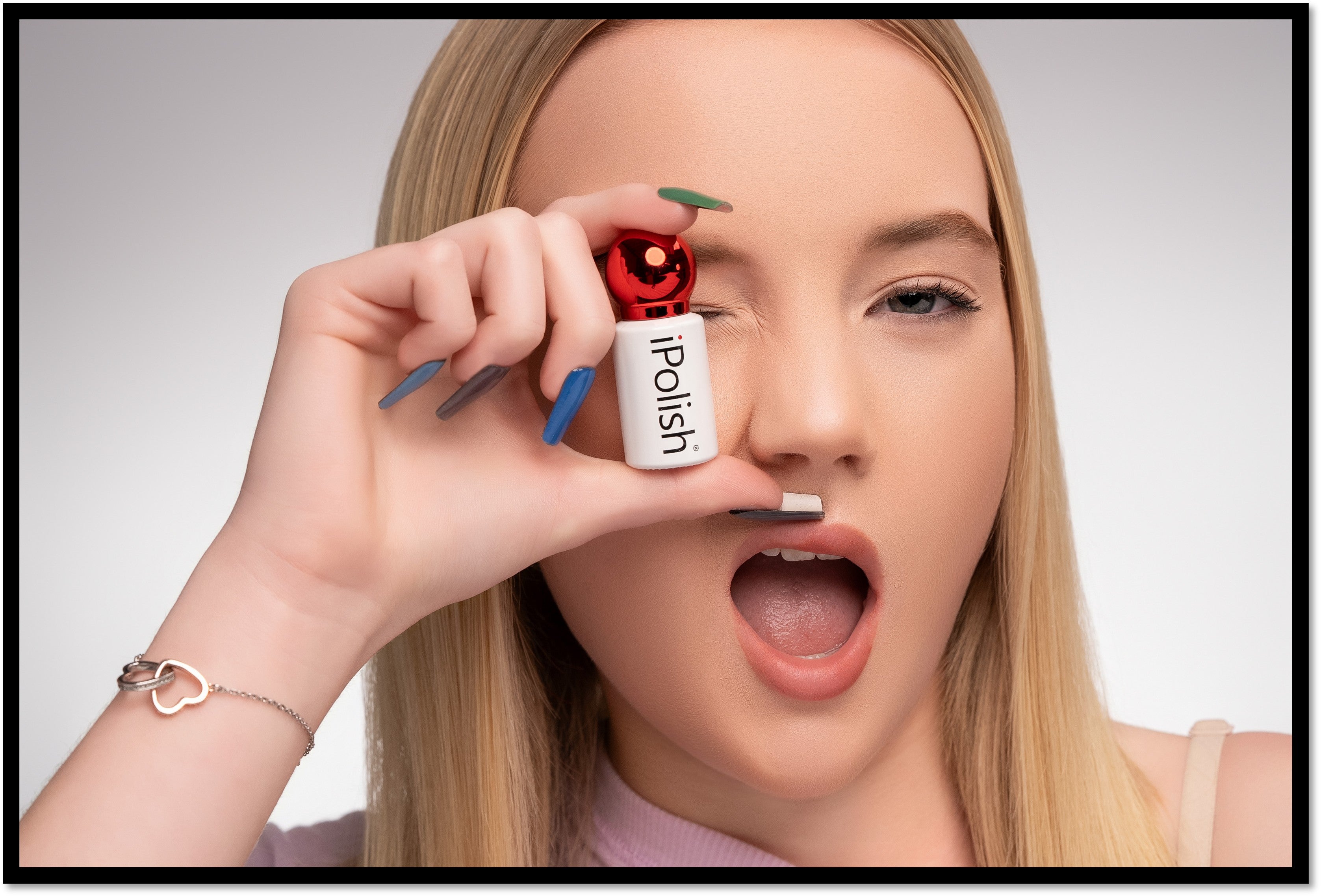 blonde woman holding polish for color changing nails